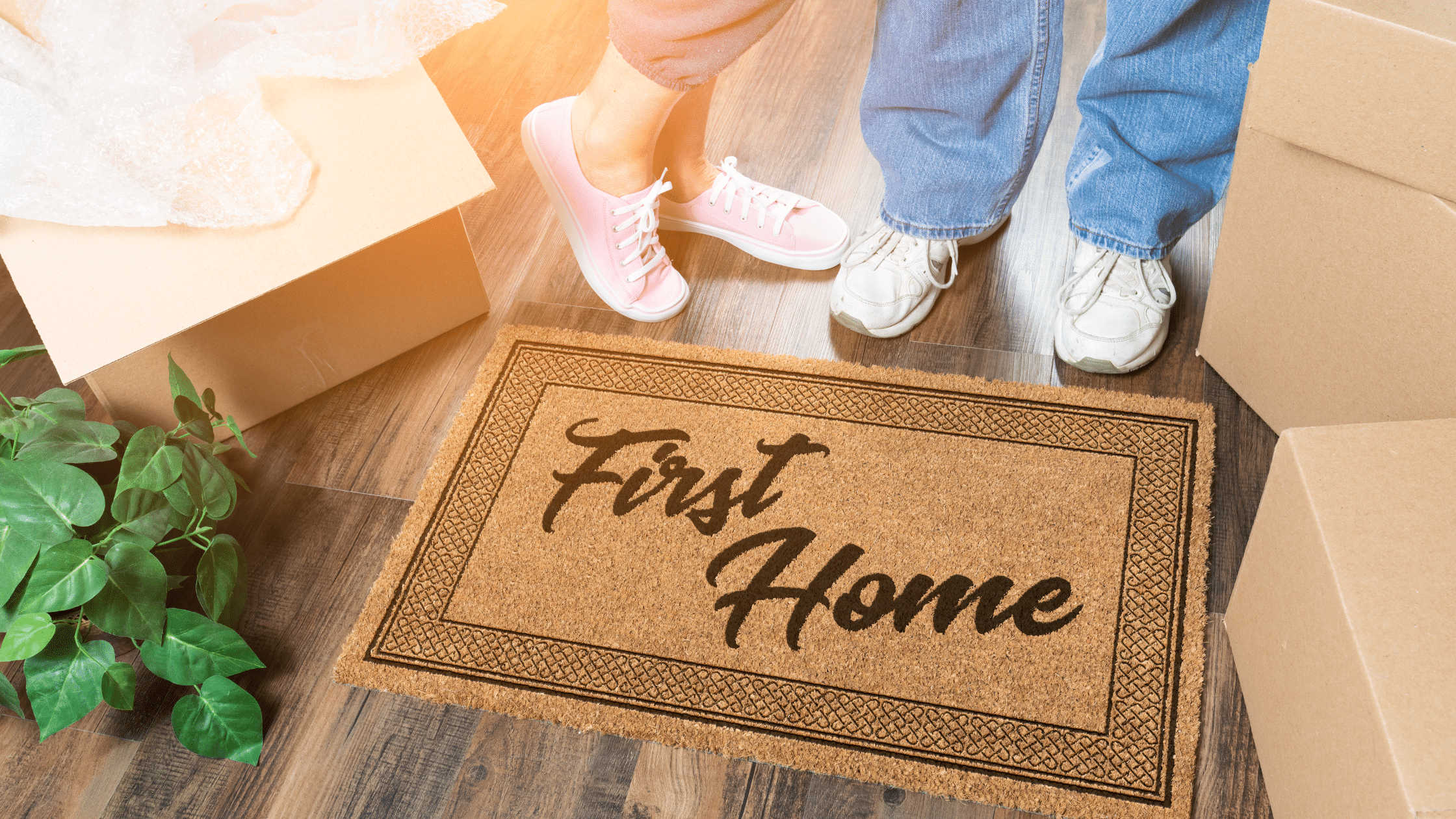 Tips for buying your first home presented with a welcome mat in a new house.
